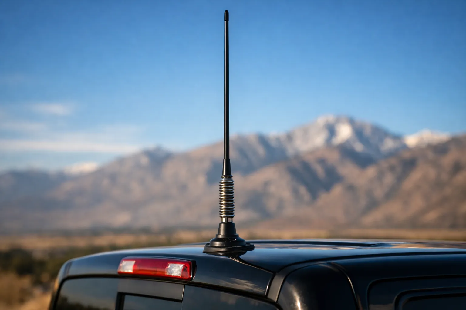 A whip antenna on a truck roof