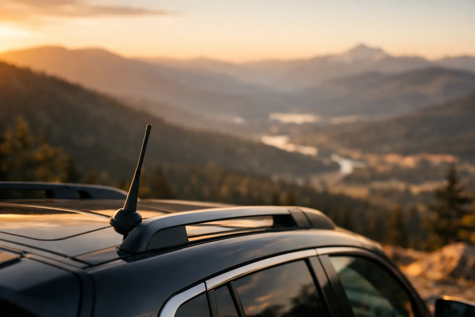 A short whip antenna on an SUV roof at a mountain overlook