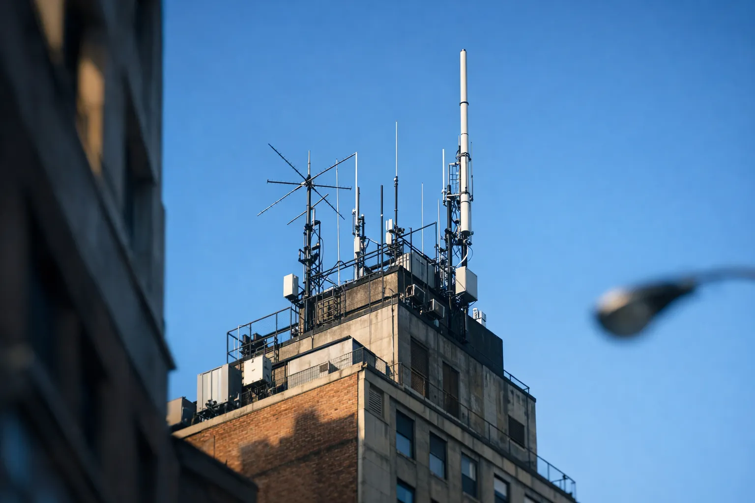 A repeater antenna on top of a tall building